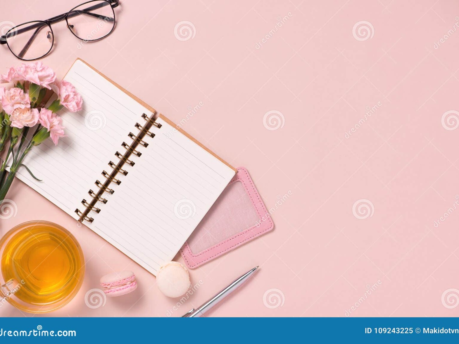 Elegant wedding budget planning workspace with laptop, calculator, coffee, and gold details on linen tablecloth